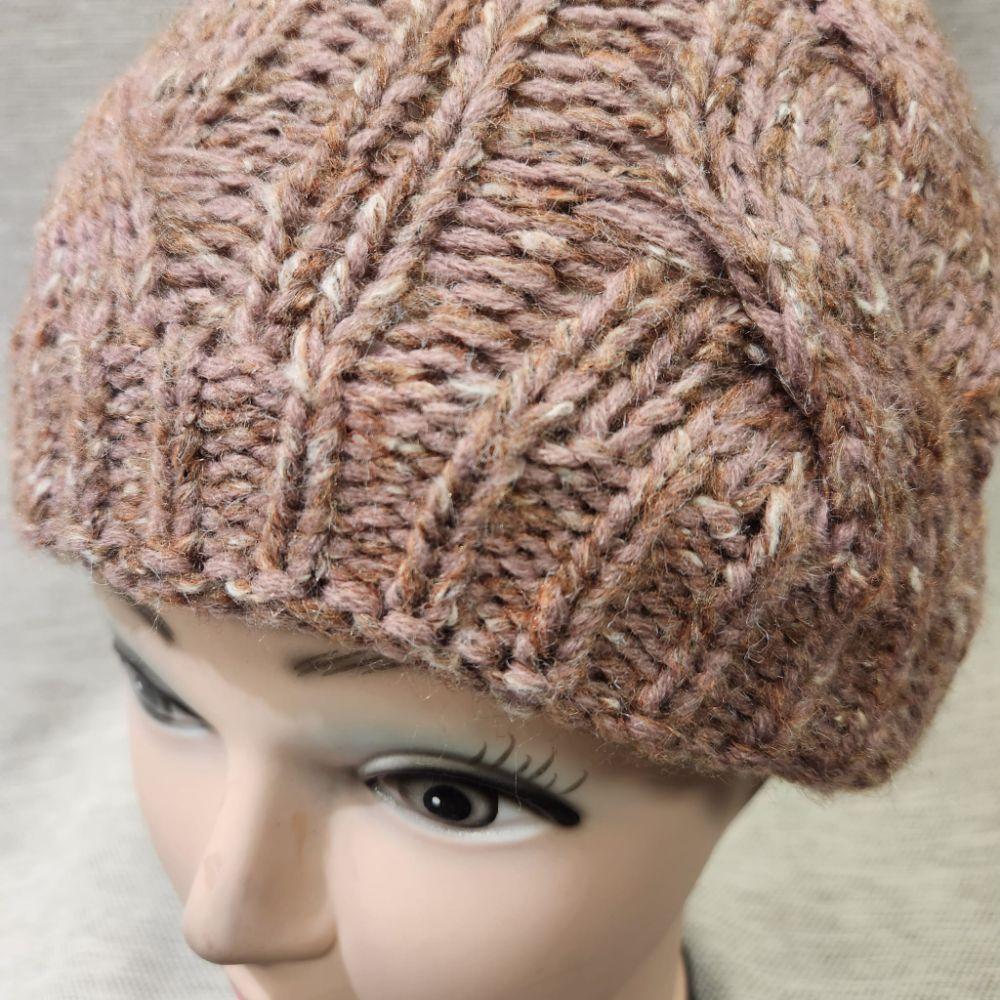Detailed view of Cinnamon pink winter beanie in pom pom