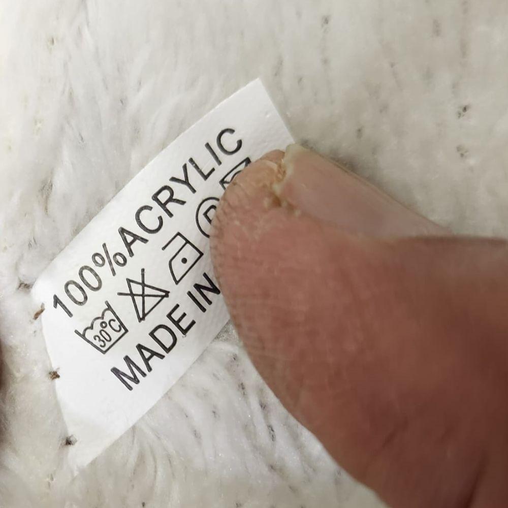 Inside tag on Cinnamon pink winter beanie in pom pom