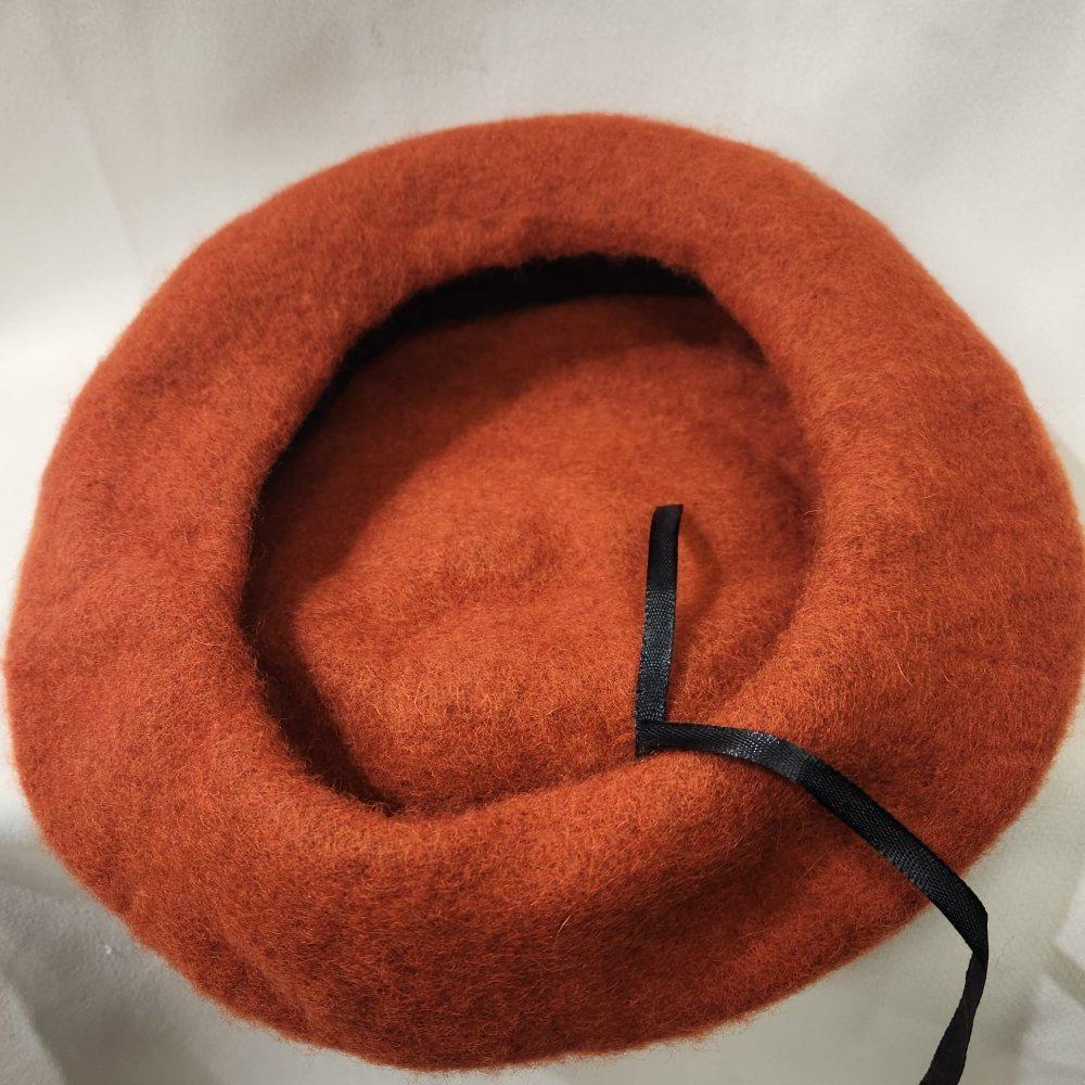 Inside view of French beret cap in rust color