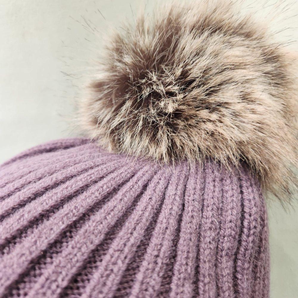 Detailed view of pom pom of lavender winter beanie