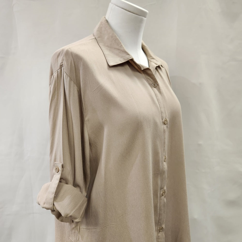 Roll up sleeves of beige dress shirt