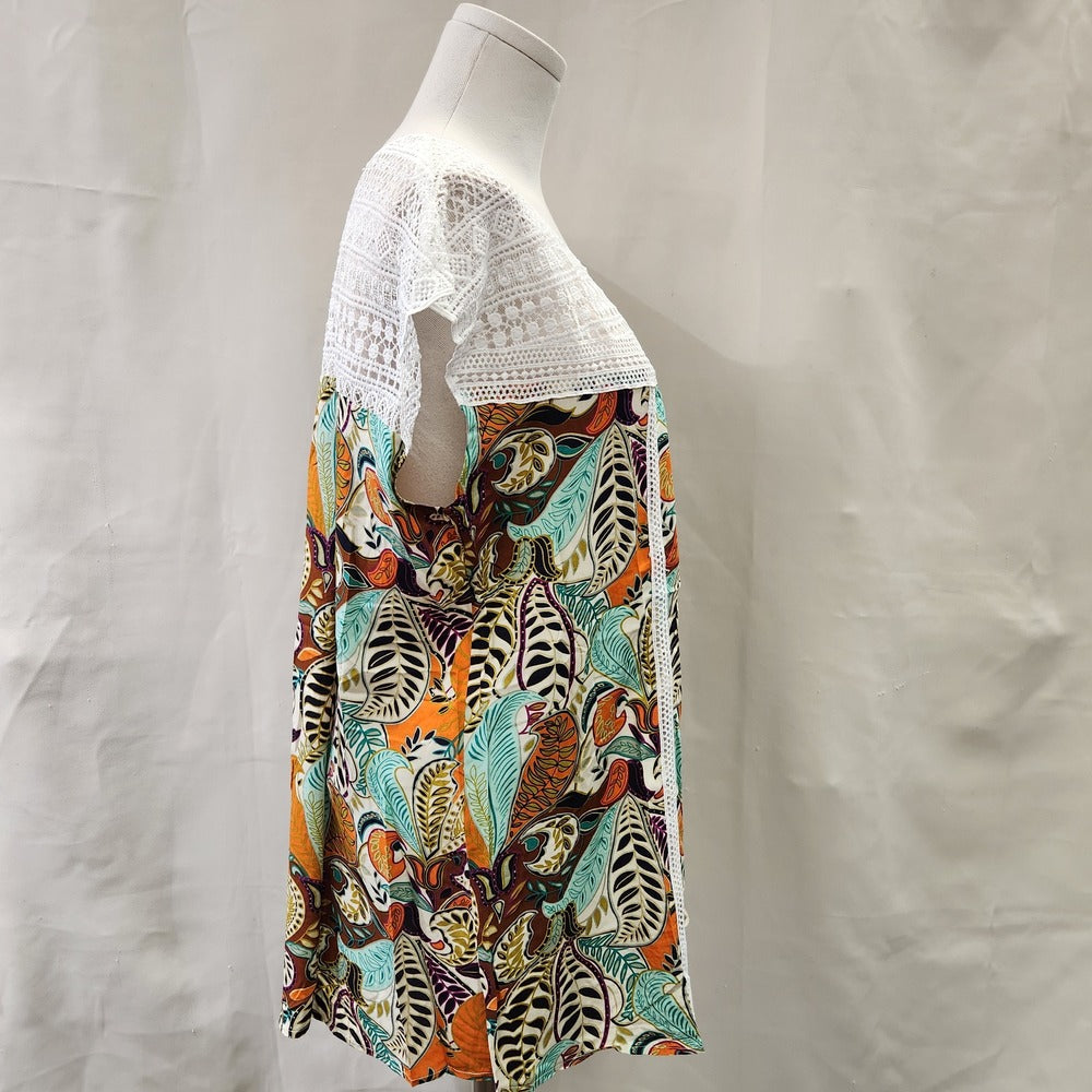 Side view of top in vibrant print and white lace upper