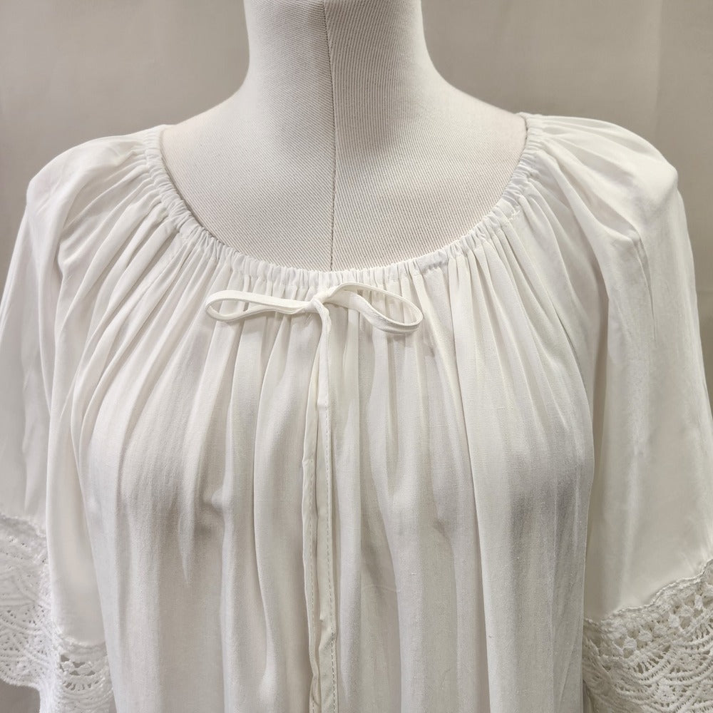 Round gathered neckline of white top