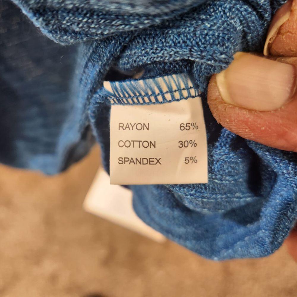 Inside tag of turquoise long sleeved top