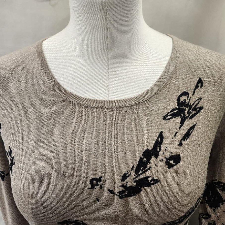 Detailed view of neckline of Closed front printed knitted top in taupe and black
