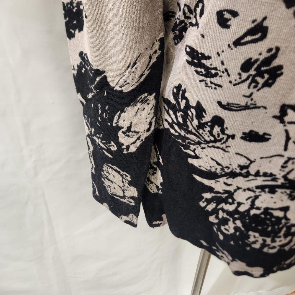 View of sleeves of Closed front printed knitted top in taupe and black