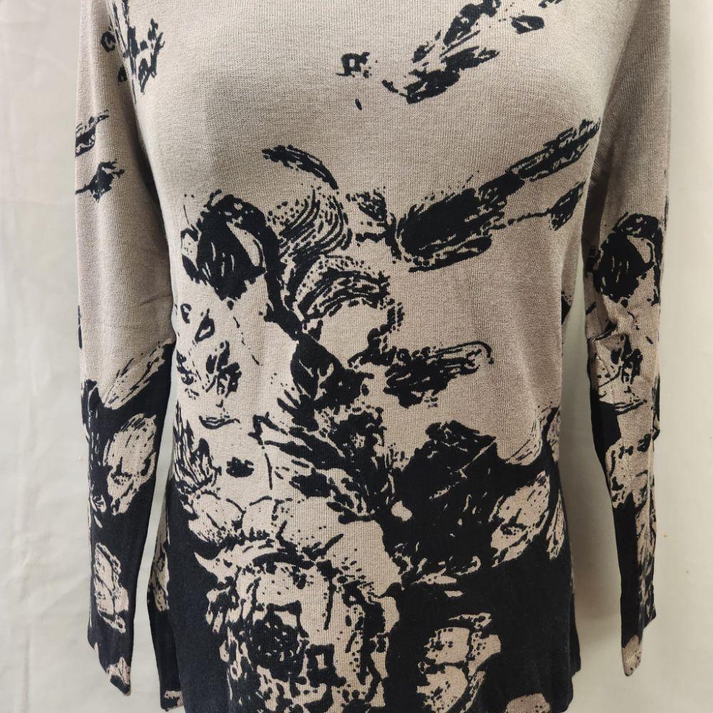 Another view of the front of printed knitted top in taupe and black