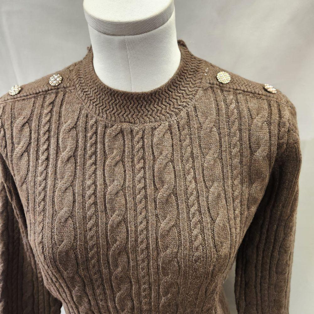 Round neckline of brown sweater