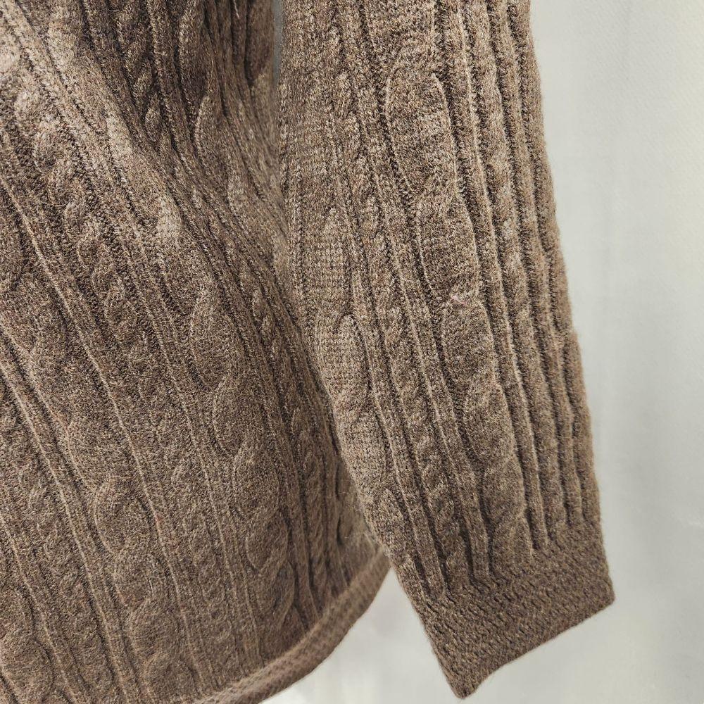 View of long sleeves of brown sweater