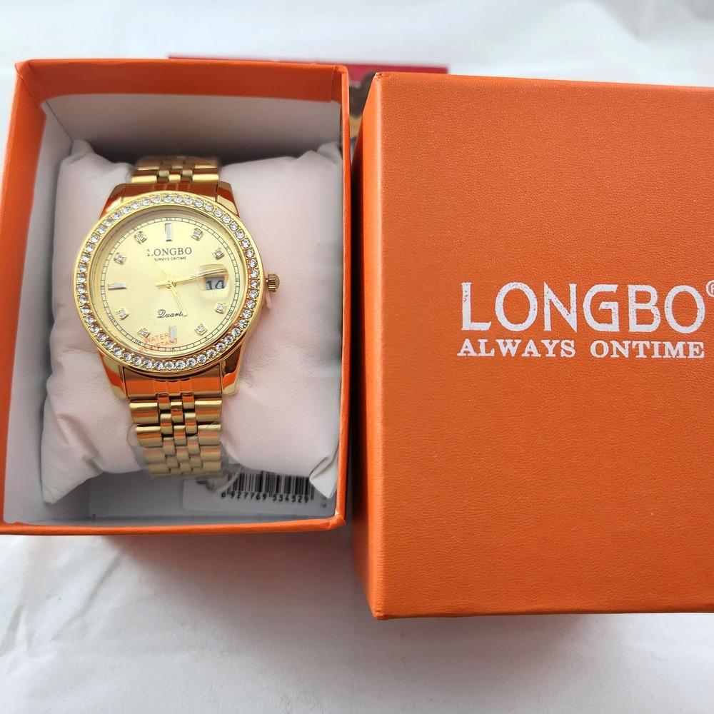 Round face stone studded rim wristwatch for men placed in a box
