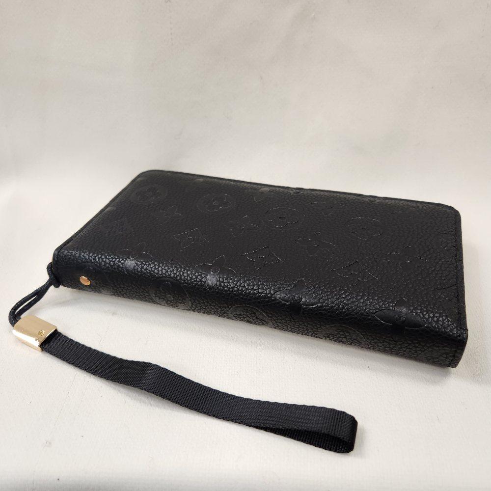 Another view of Black wallet with engraved floral pattern and black wrist strap
