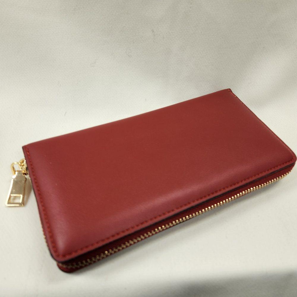 Gold hardware of red wallet