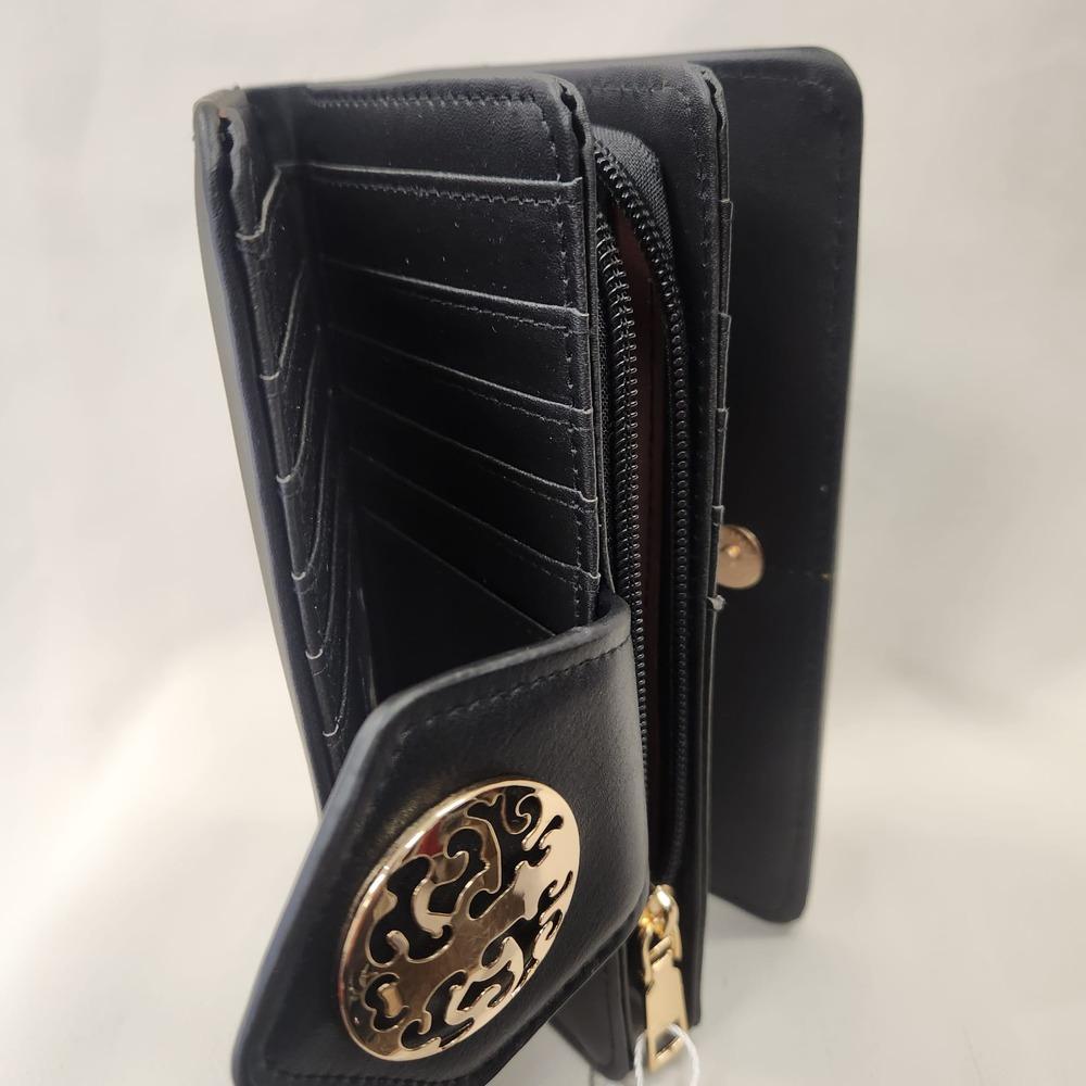 Multiple compartment black wallet with gold hardware placed vertically