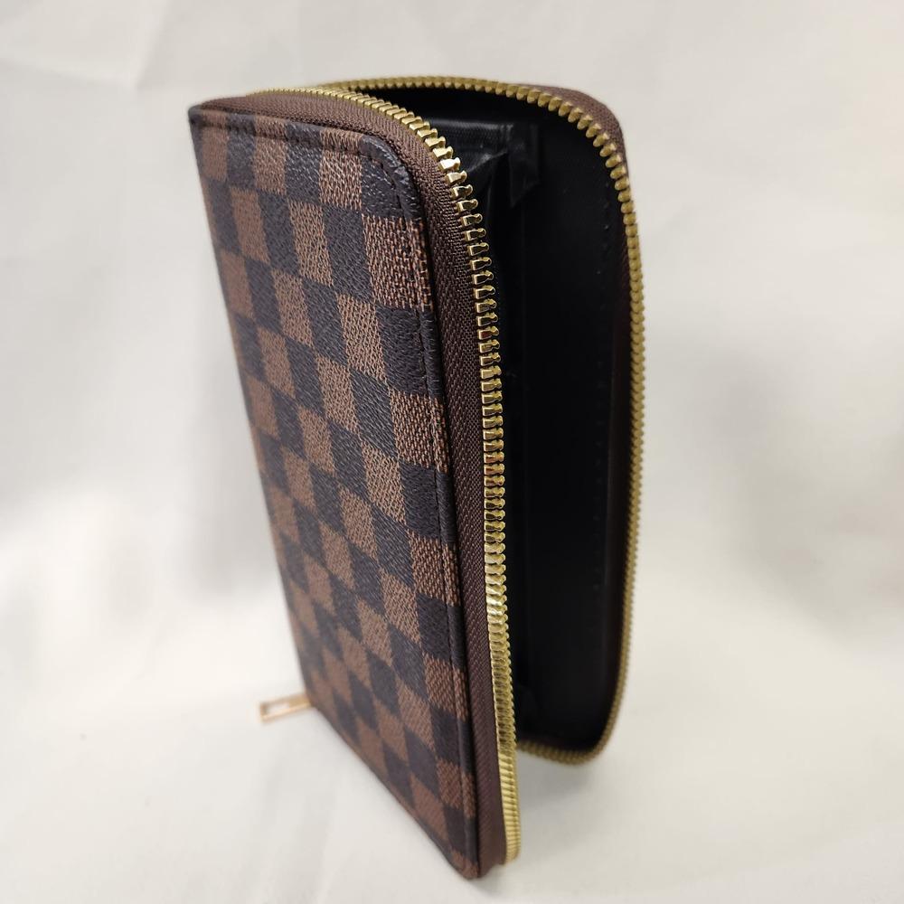 Checkered print wallet in shades of brown placed upright