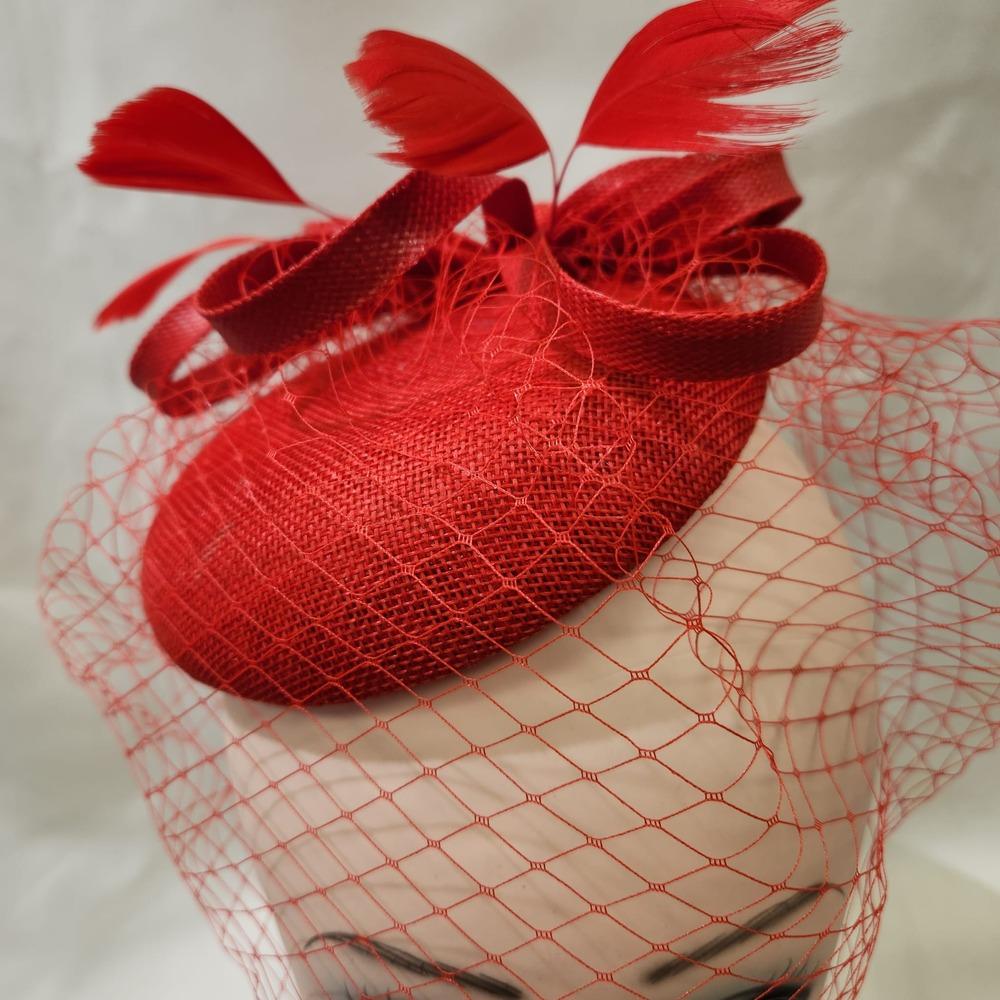 Top view of elegant cambric fascinator in red
