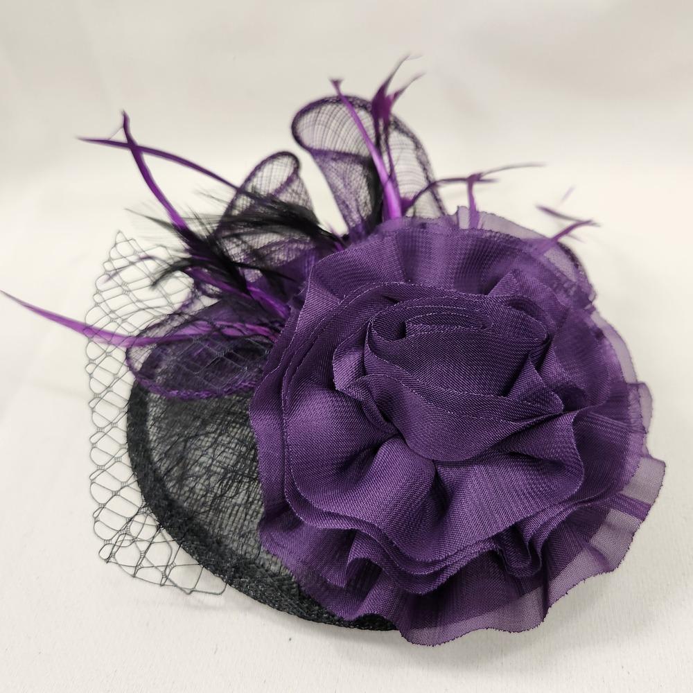 Top view of Black and purple fascinator with feathers and net