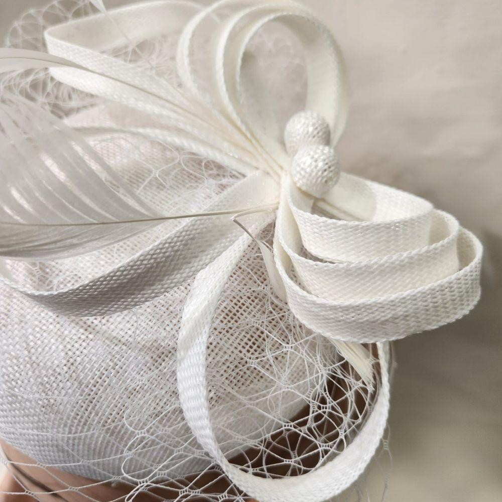 Detailed view of Elegant cambric fascinator in white with veil