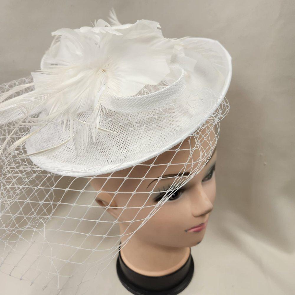 White cambric fascinator with feathers and net veil opened up