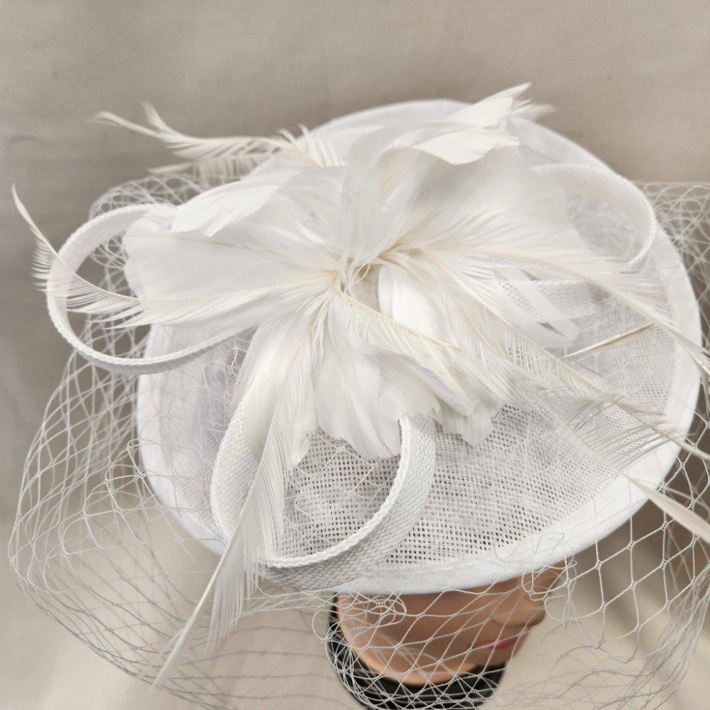 Top view of White cambric fascinator with feathers and net veil
