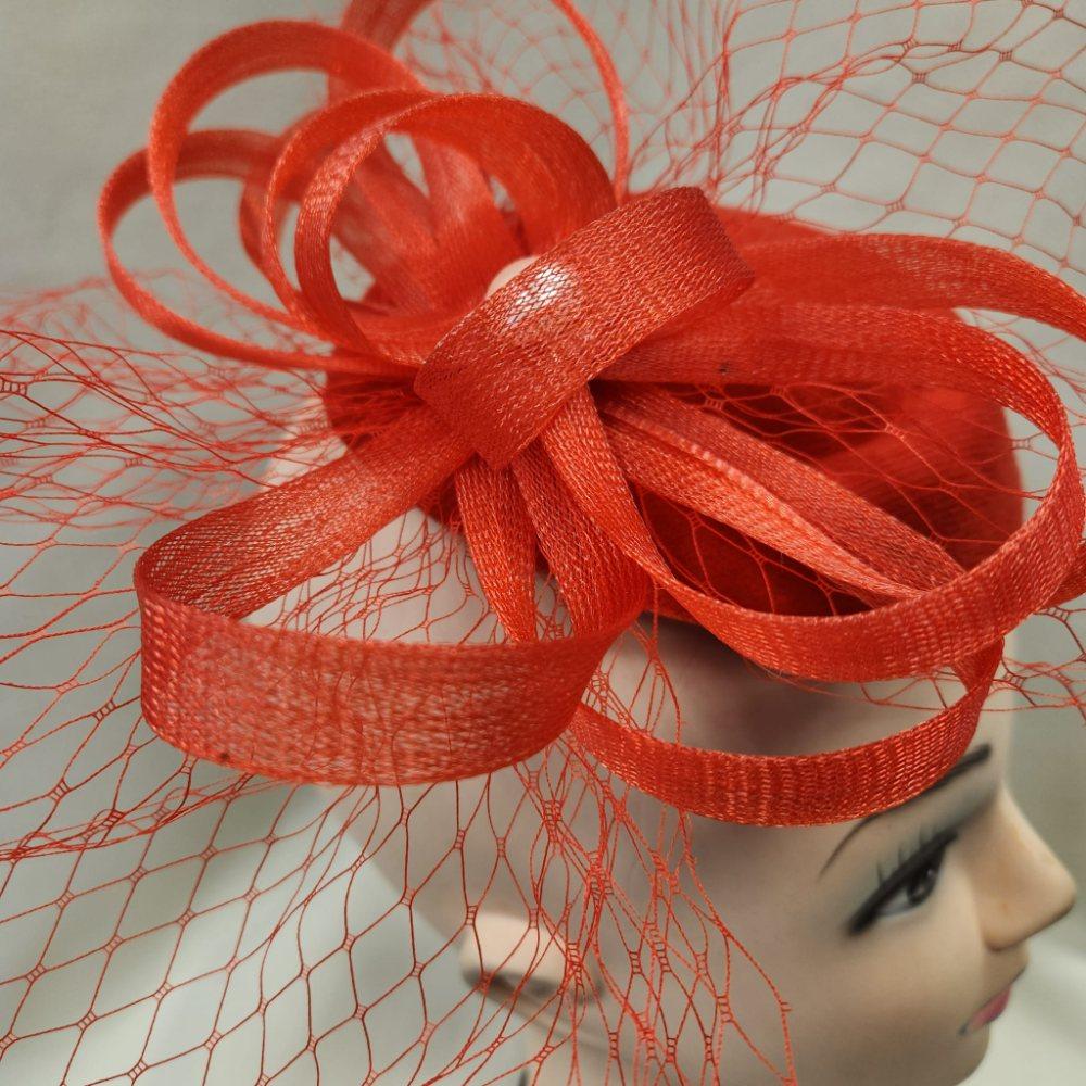 Detailed view of Elegant red cambric base fascinator with veil
