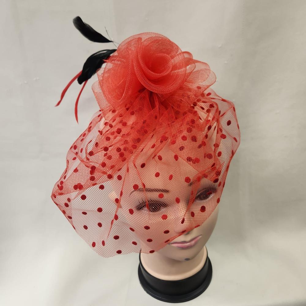 Front view of Red fascinator with mesh and feather detail