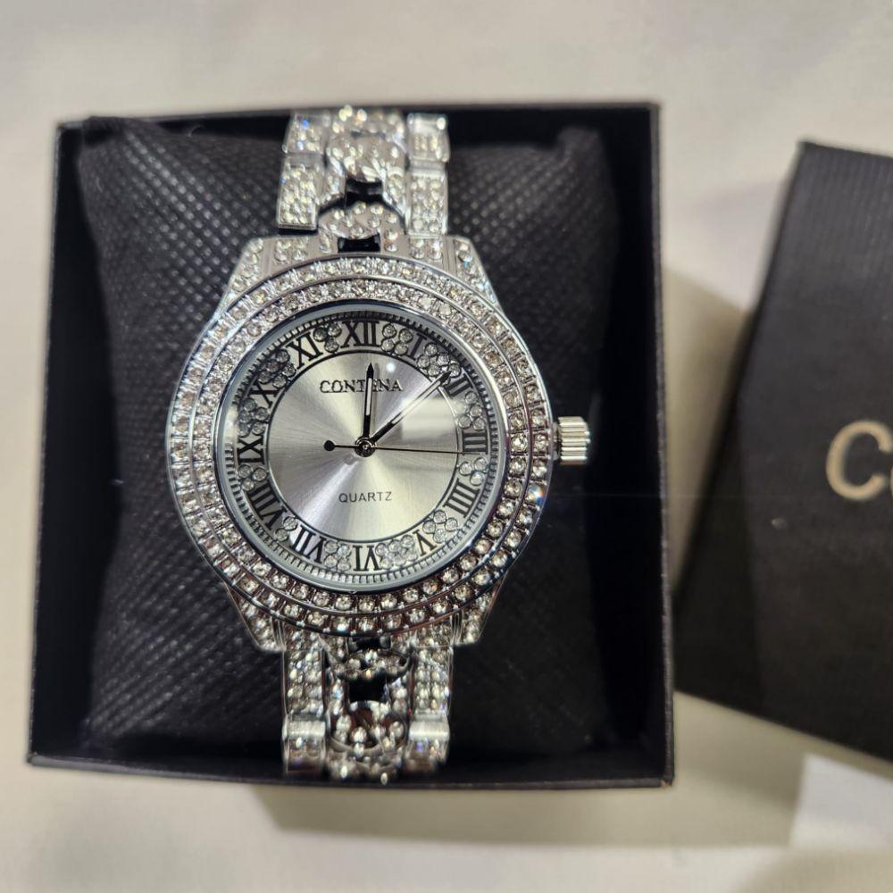 Detailed view of Silver color wristwatch with stone studded rim and strap