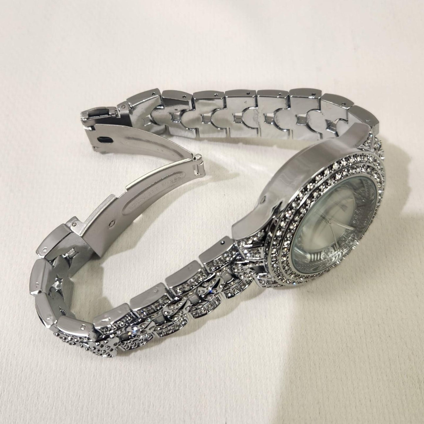Folding clasp of silver stone studded wristwatch