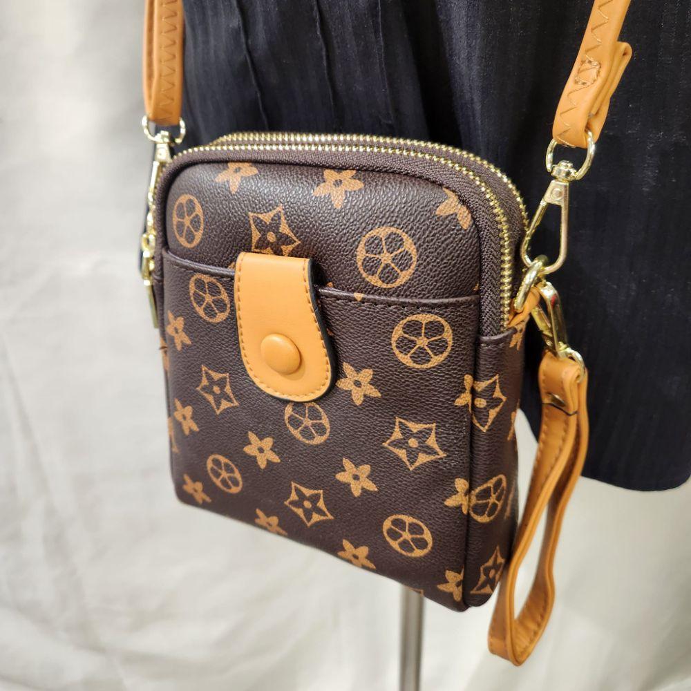 Tan wristlet on the floral side bag