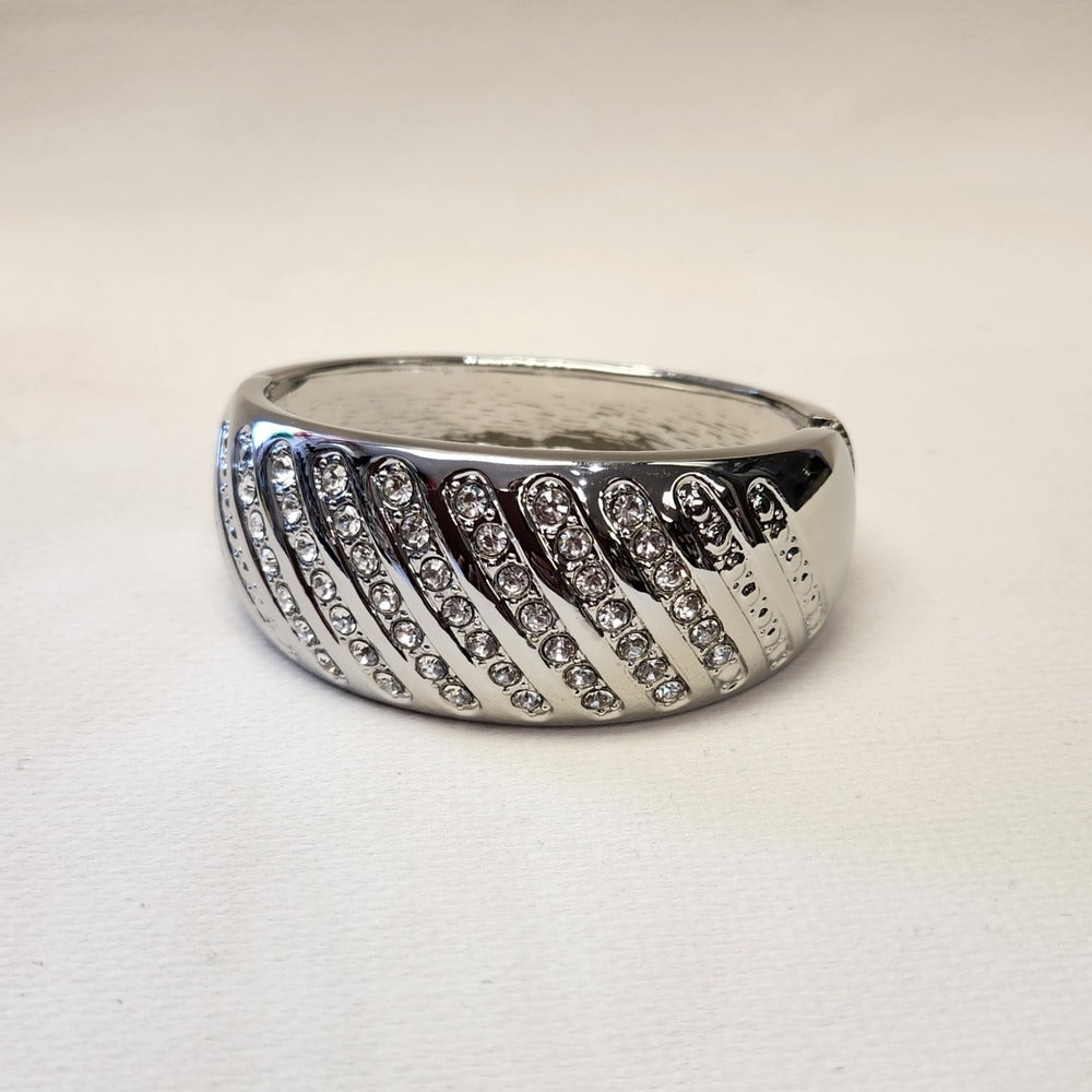 Detailed view of modern silver color hinged bracelet
