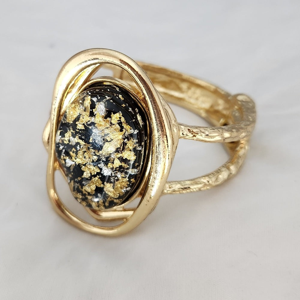 Hinged bracelet with resin filled center stone