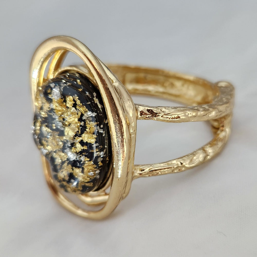 Partial side view of Hinged bracelet with resin filled center stone