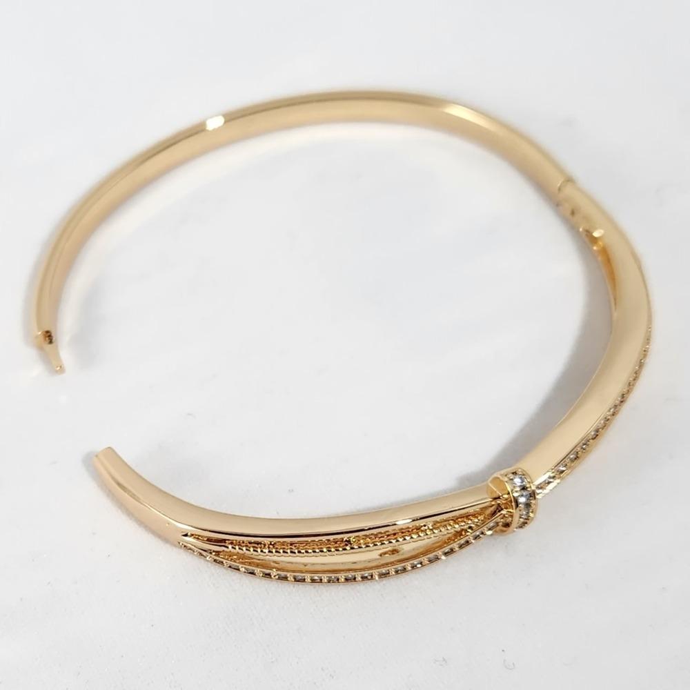 Hinged closure of modern design gold bracelet