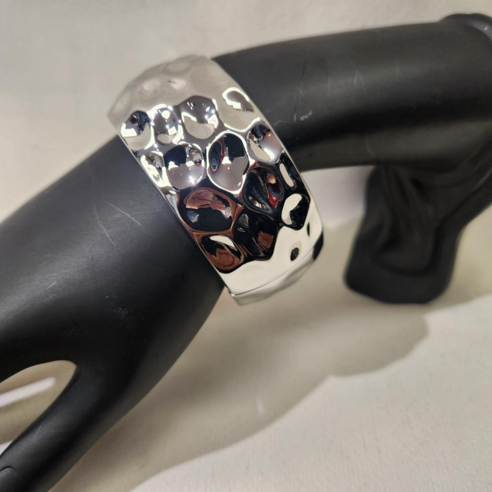 Detailed view of Textured silver hinged bracelet