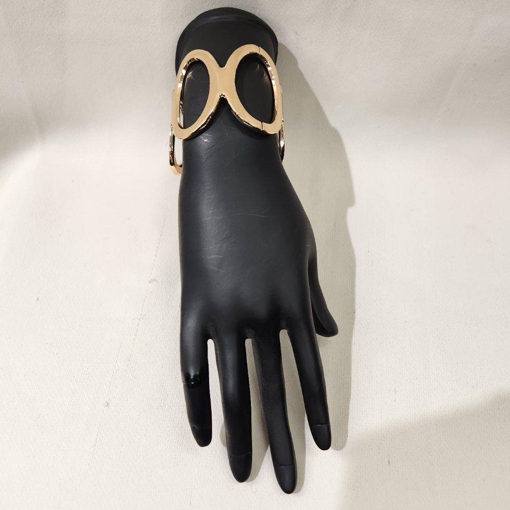 Front view of trendy gold hinged bracelet