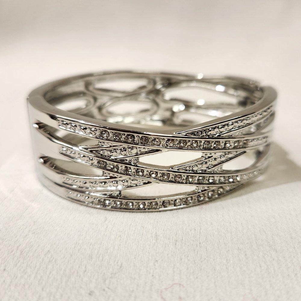 Detailed view of Silver color trendy hinged bracelet with stones