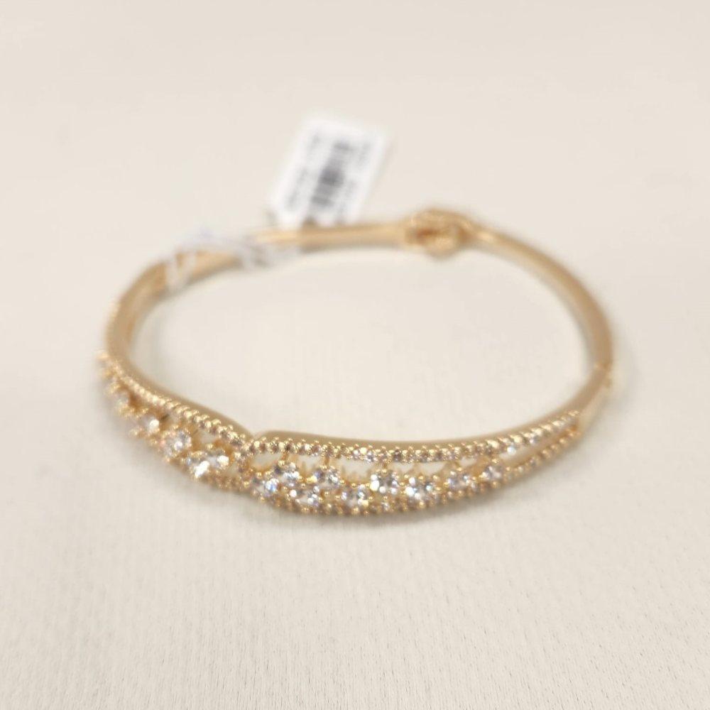 Fold over closure of dainty gold bracelet