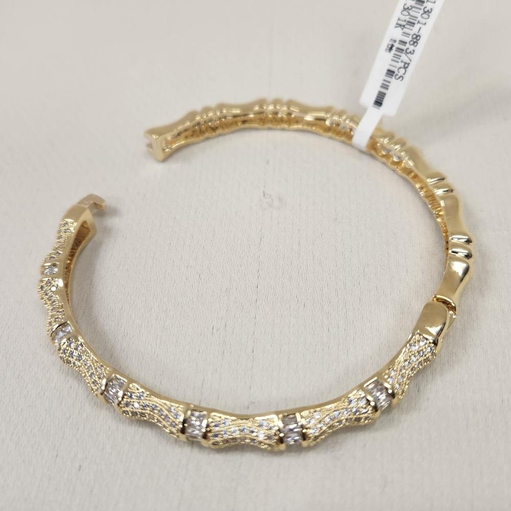 detailed view of gold bracelet with dazzling stones