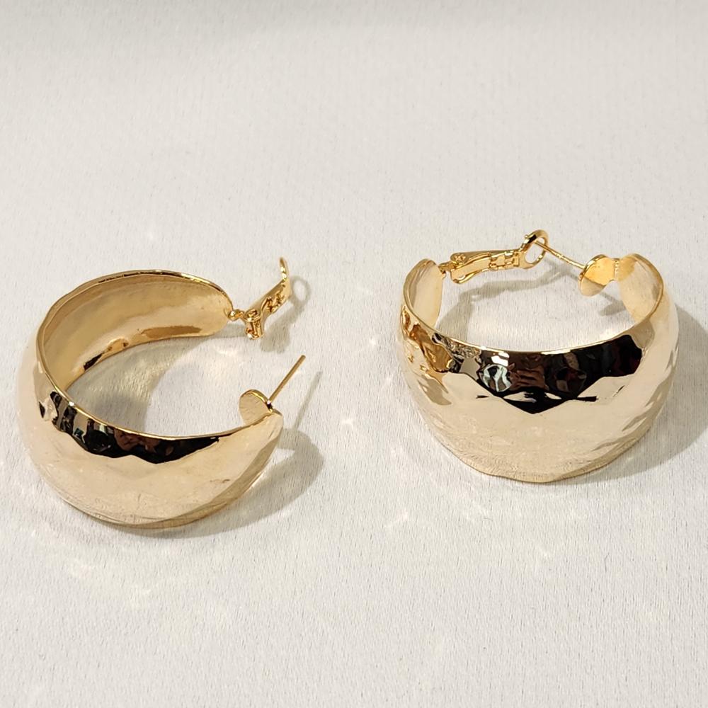 Lever back post of wide gold textured hoop earrings