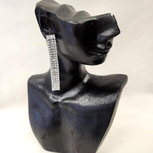 Long silver color earrings with round and baguette shaped stones