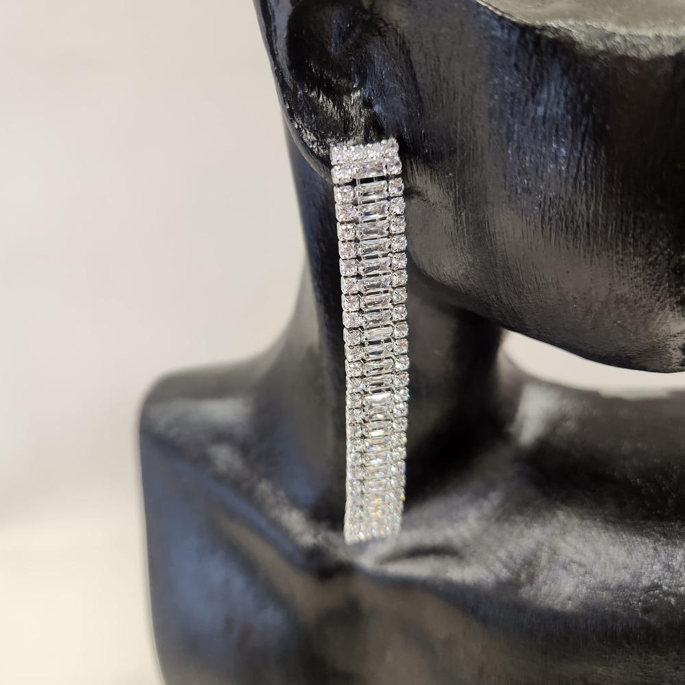 Detailed view of long sparkling dangle earrings