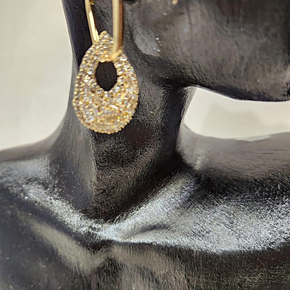 Detailed view of Elegant gold dangle earrings with multi cut stones