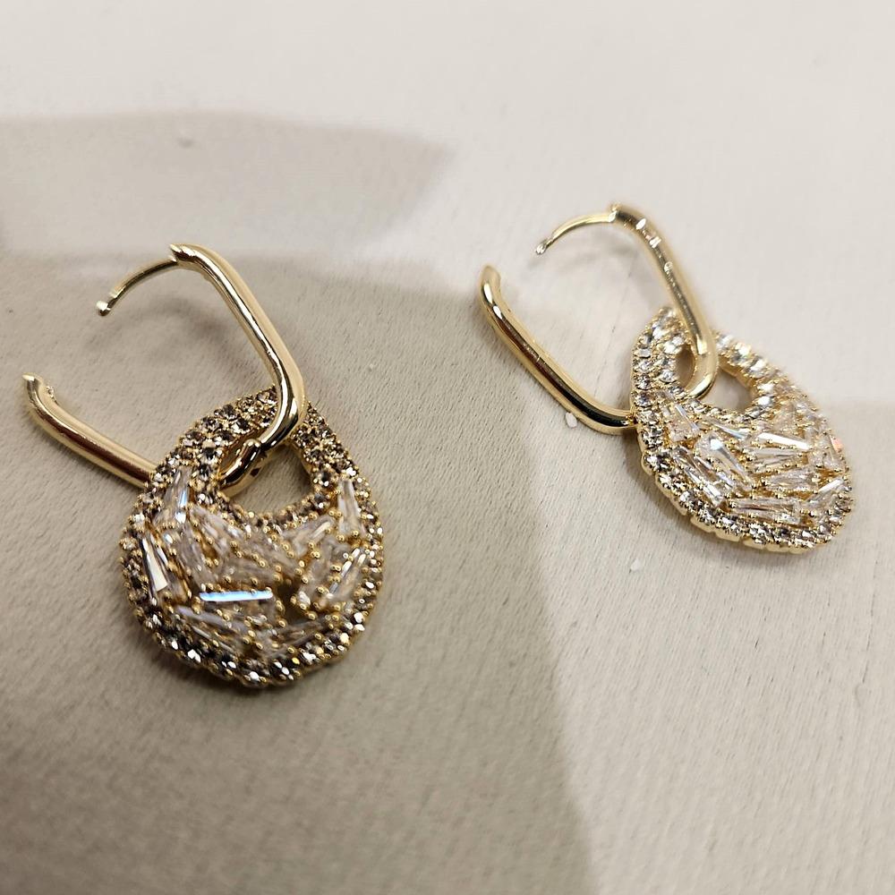 Latch back post of gold dangle earrings