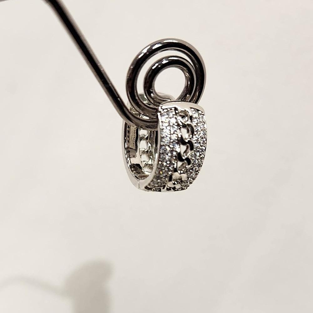 Detailed front view of Small hoop silver hued earrings