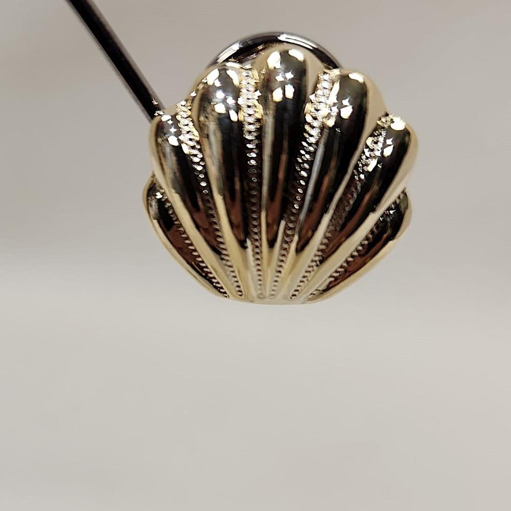 Detailed view of Gold seashell clip on earrings