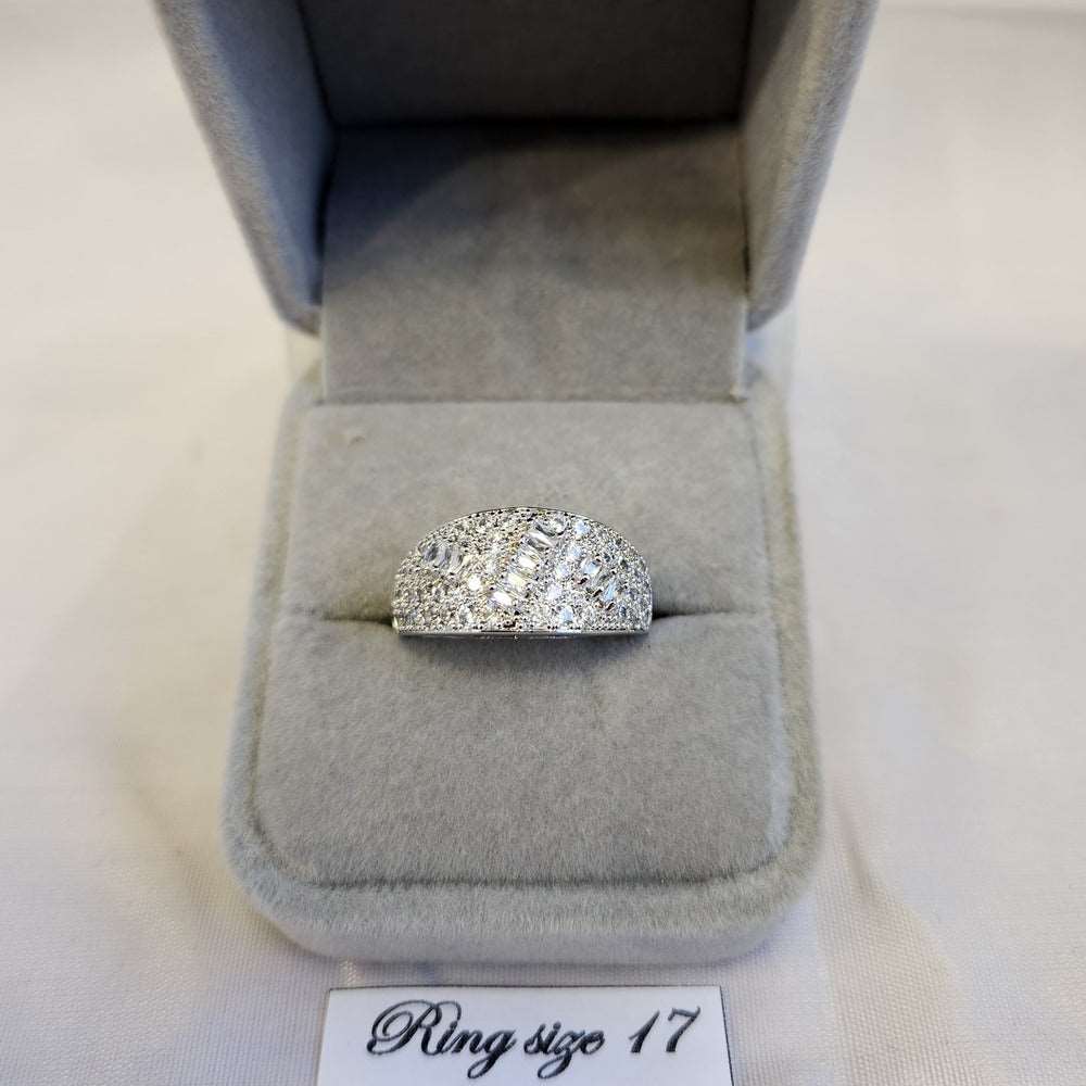Broad band ring with round and baguette shaped stones