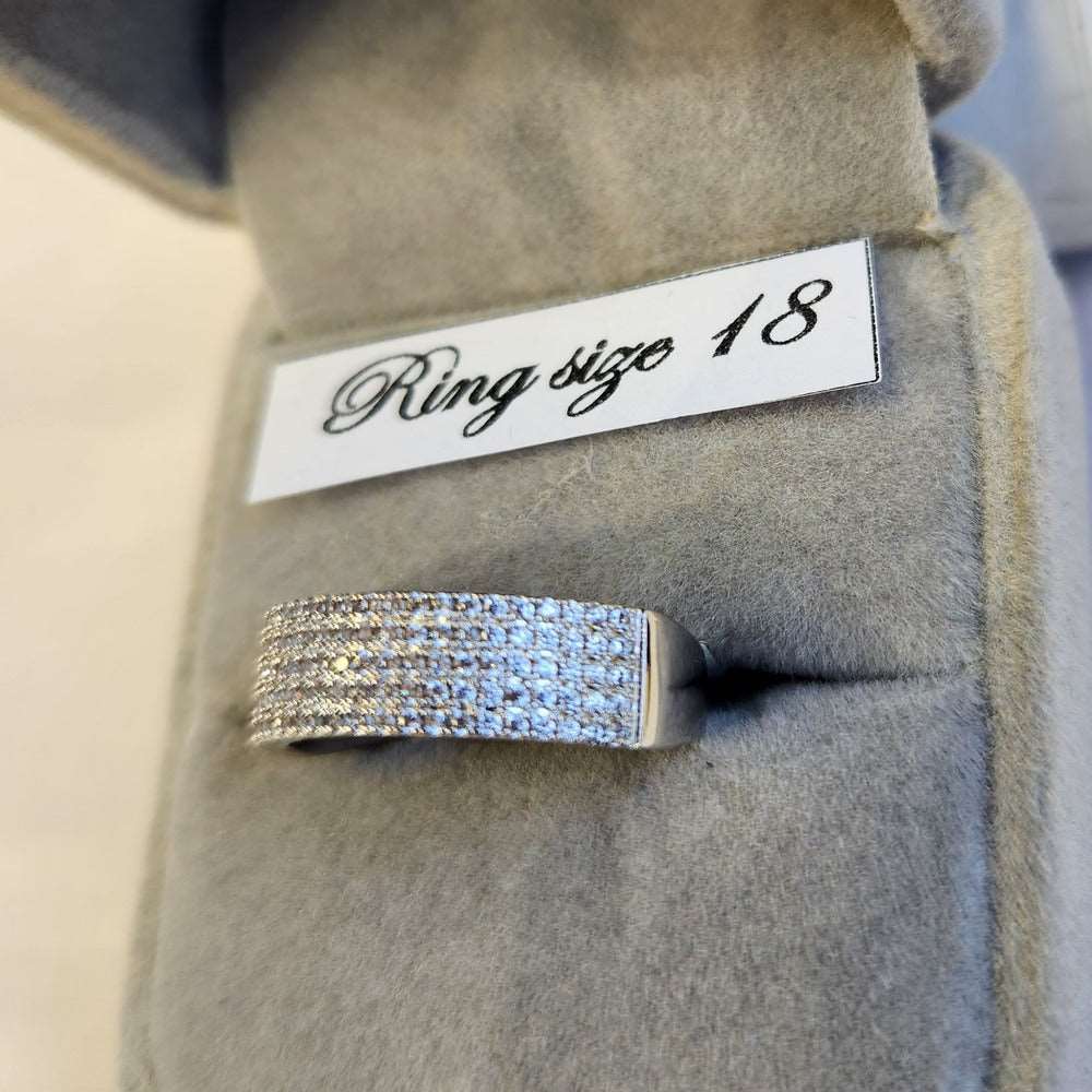 Detailed view of five row stone set silver colored ring