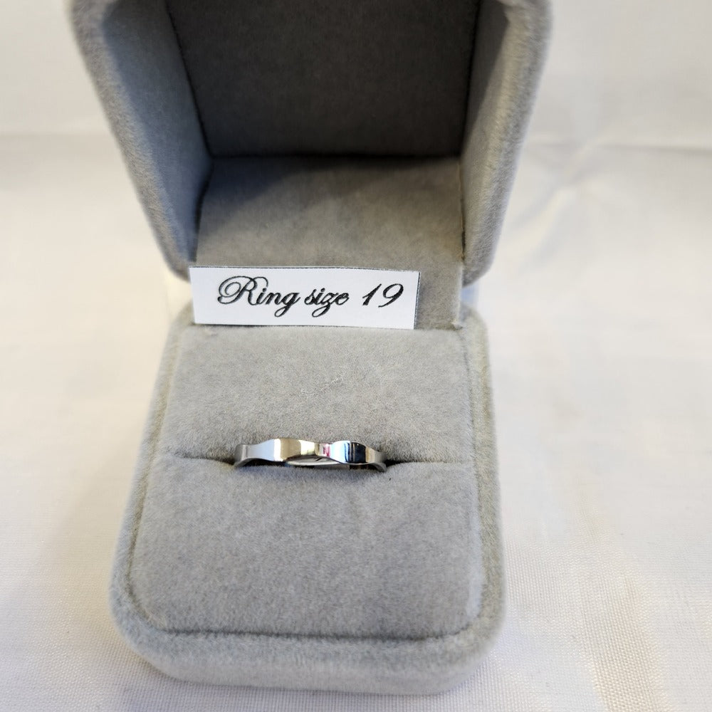Detailed view of Silver colored wave band ring