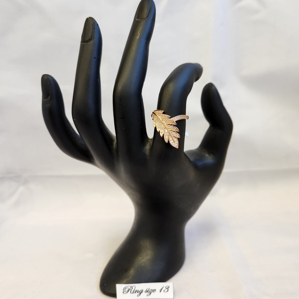 Leaf shaped rose gold ring in size 13 displayed on a mannequin stand