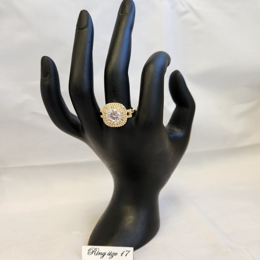 Cushion set gold color ring displayed on a mannequin stand