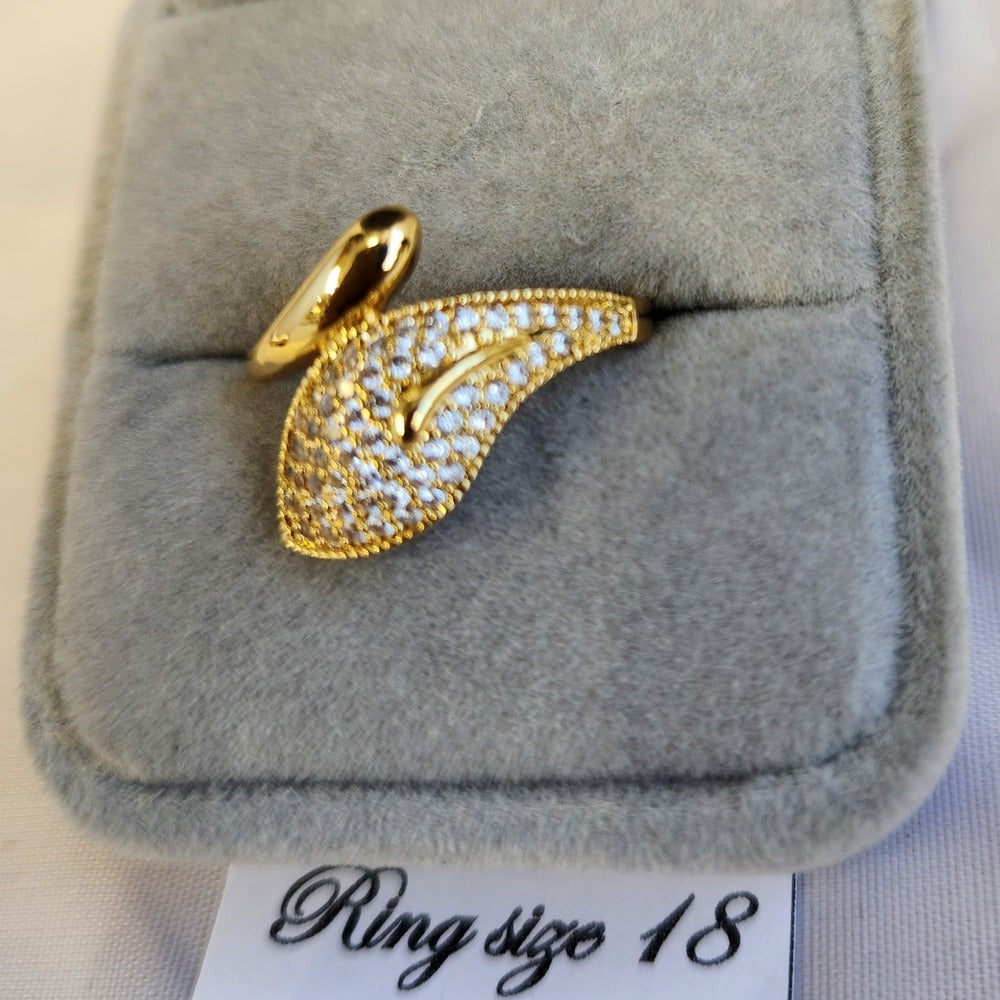 Detailed view of gold frame ring set with clear stones